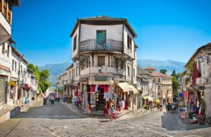GJIROKASTER, ALBANIA - JUNE 07, 2014: Unidentified locals in a street scene at the center of historic town of Gjirokasteron June 07, 2014 in Gjirokaster, Albania. World Heritage Site by UNESCO